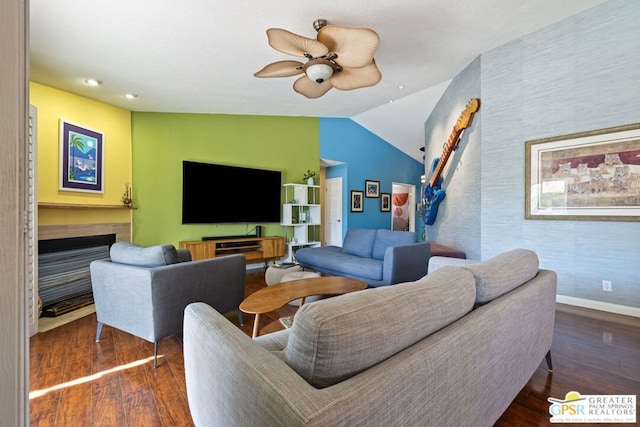 living room featuring dark hardwood / wood-style floors, ceiling fan, and vaulted ceiling