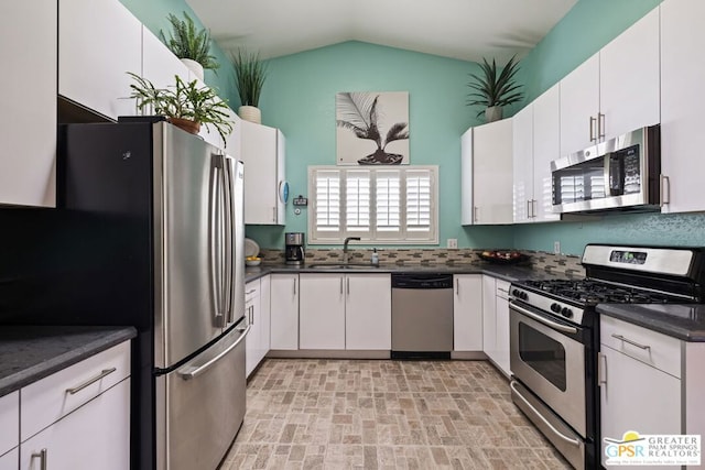 kitchen featuring stainless steel appliances, white cabinetry, and sink