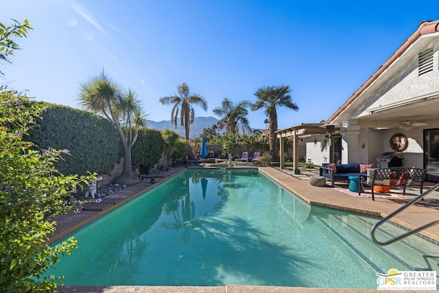 view of swimming pool featuring a patio area and a mountain view