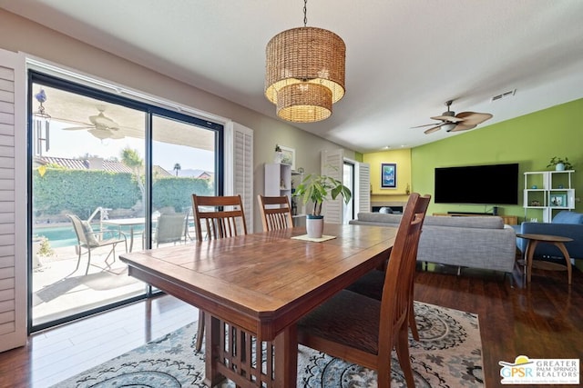 dining space with lofted ceiling, ceiling fan, and wood-type flooring