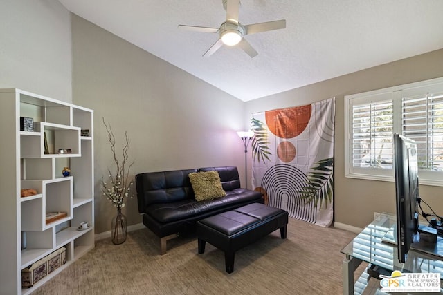 living area with carpet flooring, ceiling fan, and vaulted ceiling