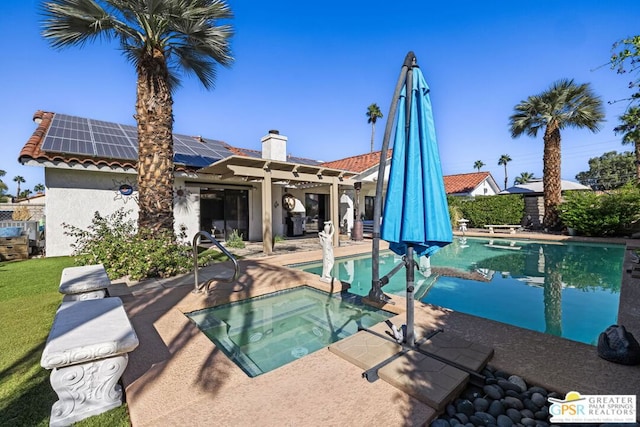 view of swimming pool with an in ground hot tub and a patio