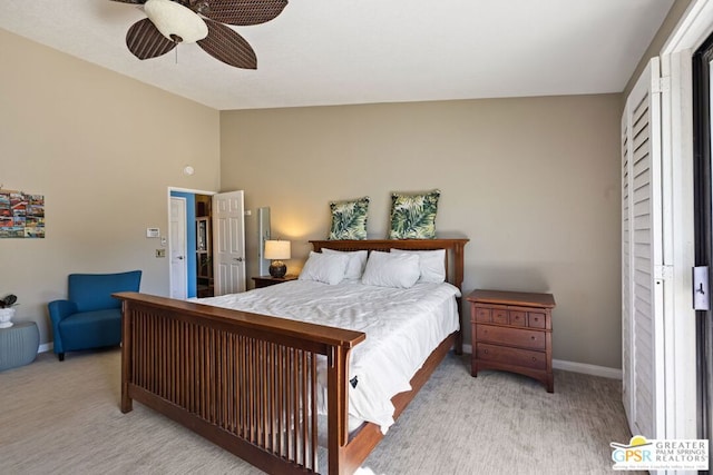 bedroom featuring ceiling fan, light carpet, and lofted ceiling