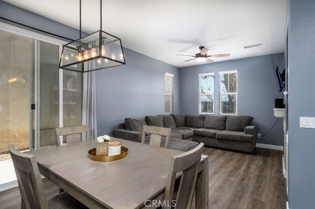 dining space featuring ceiling fan and dark hardwood / wood-style flooring