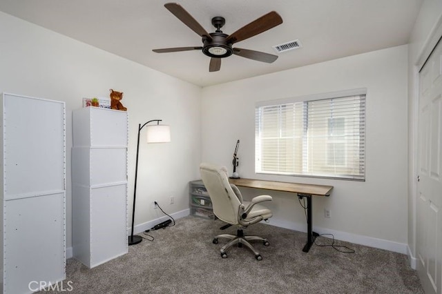 unfurnished office with ceiling fan and light colored carpet