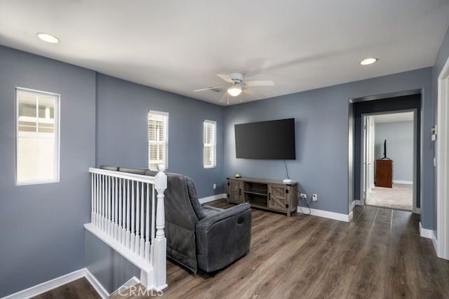 living room featuring dark hardwood / wood-style flooring and ceiling fan