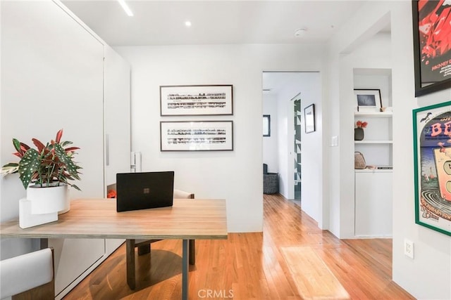 office area with light hardwood / wood-style floors