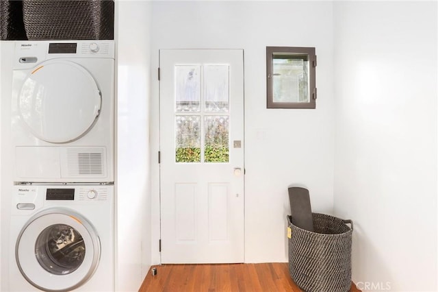 washroom featuring stacked washer / drying machine and light wood-type flooring