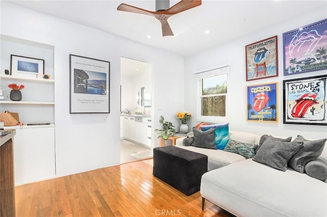 living room featuring light wood-type flooring and ceiling fan