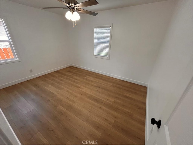 spare room featuring wood-type flooring and ceiling fan