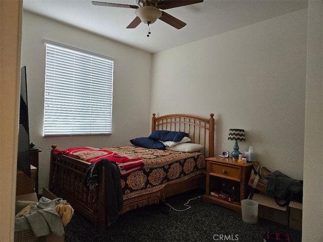 carpeted bedroom with multiple windows and ceiling fan