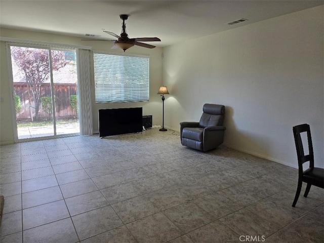 unfurnished room featuring ceiling fan and light tile patterned floors