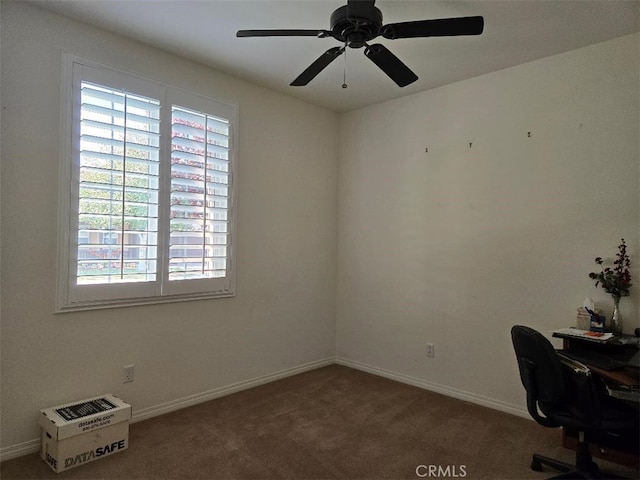 unfurnished office featuring carpet flooring and ceiling fan