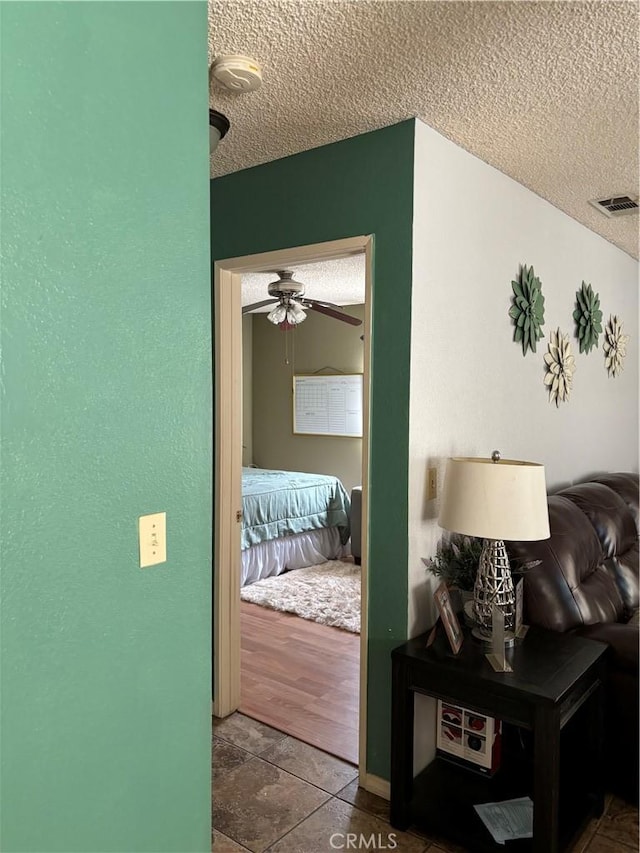 hall featuring hardwood / wood-style flooring and a textured ceiling