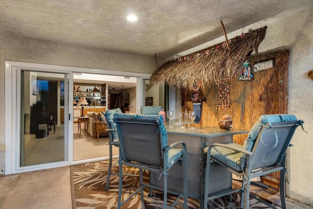 dining area with a textured ceiling and concrete floors