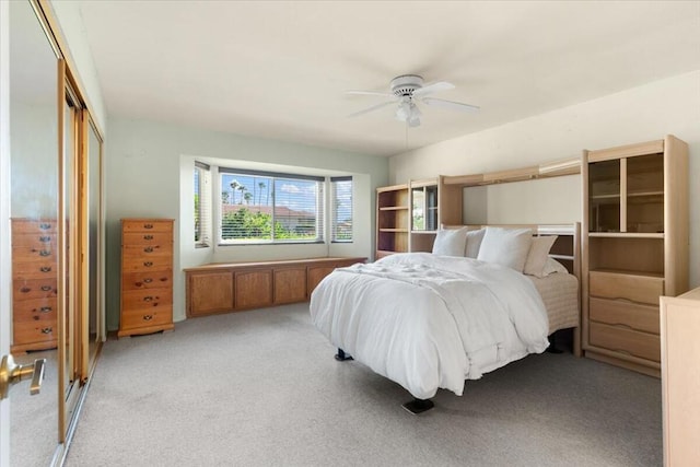 carpeted bedroom featuring a closet and ceiling fan