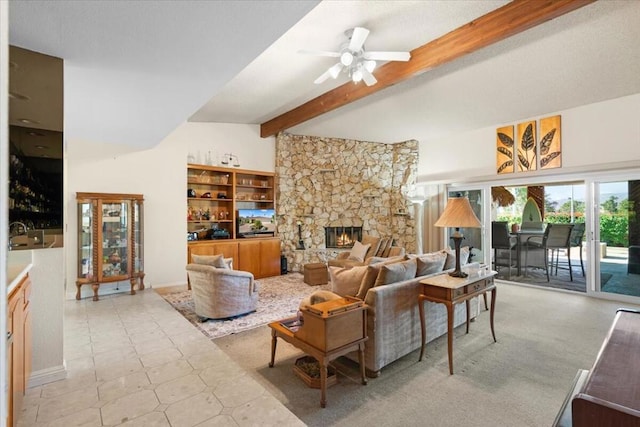 living room featuring ceiling fan, lofted ceiling with beams, and a stone fireplace