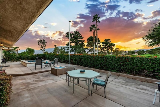 patio terrace at dusk with a fire pit