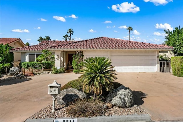 mediterranean / spanish-style home with a garage