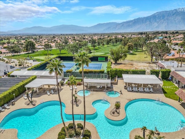 view of swimming pool with a mountain view