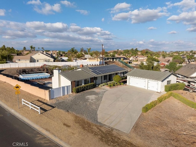 view of front of property with solar panels and a garage