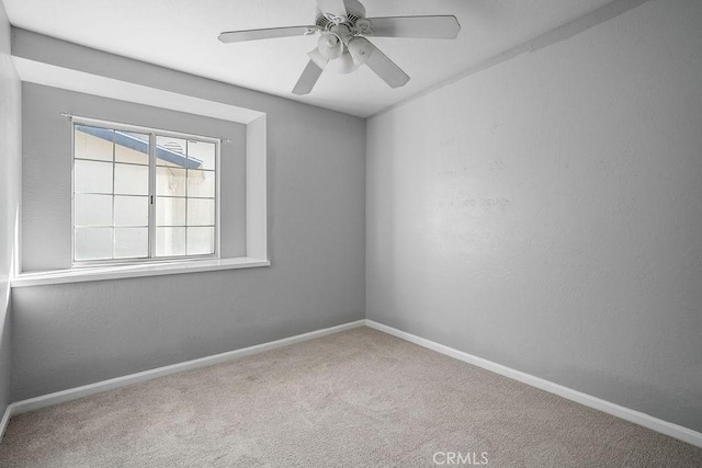 carpeted empty room with ceiling fan