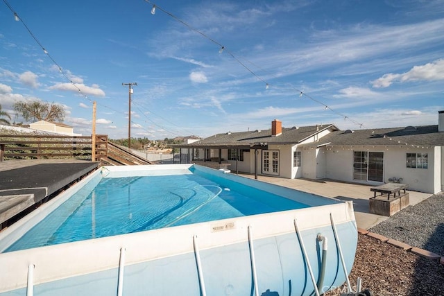 view of pool with a patio area and french doors