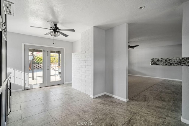 interior space featuring ceiling fan, a textured ceiling, and french doors