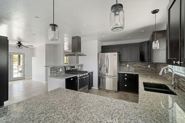 kitchen with kitchen peninsula, appliances with stainless steel finishes, sink, and exhaust hood