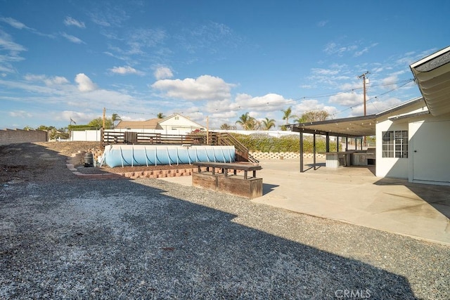 view of yard featuring a patio area and a fenced in pool