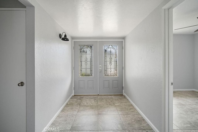 doorway to outside featuring ceiling fan, french doors, and light tile patterned flooring