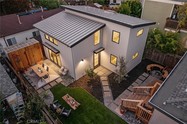 exterior space featuring an outdoor fire pit and a patio