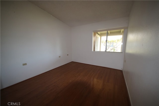 unfurnished room featuring dark hardwood / wood-style floors