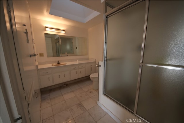 bathroom with vanity, toilet, and a shower with door