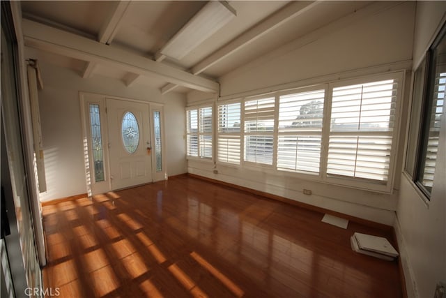 entrance foyer featuring vaulted ceiling with beams, hardwood / wood-style floors, and a healthy amount of sunlight