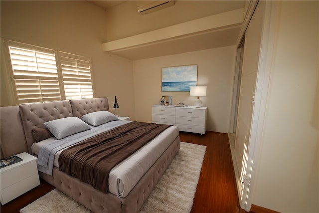 bedroom featuring dark hardwood / wood-style flooring and a wall mounted air conditioner