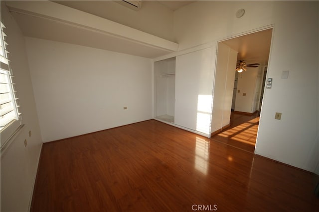 unfurnished room with dark hardwood / wood-style floors and ceiling fan