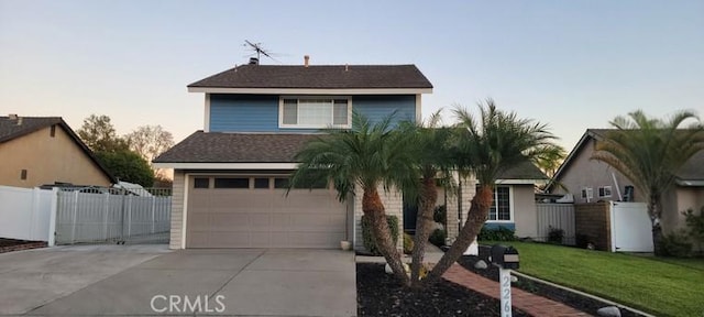 view of front of home with a garage and a yard