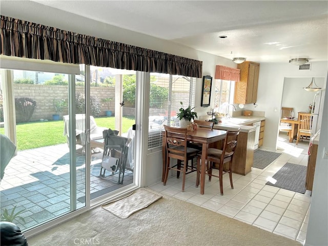 tiled dining room with sink