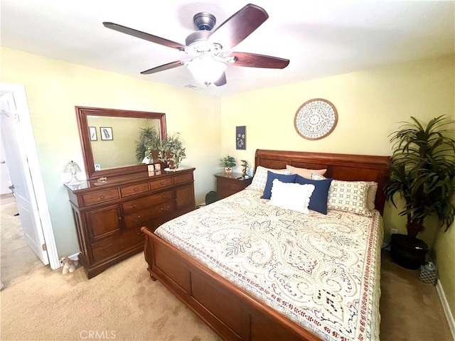 bedroom with light carpet and ceiling fan