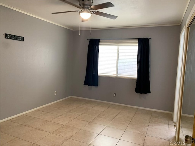 tiled spare room featuring ceiling fan and ornamental molding