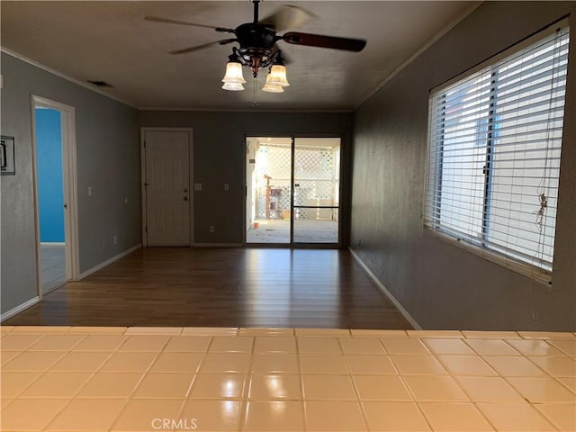 empty room with hardwood / wood-style floors, ceiling fan, and ornamental molding