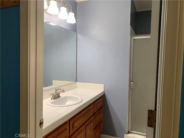 bathroom featuring vanity and an enclosed shower