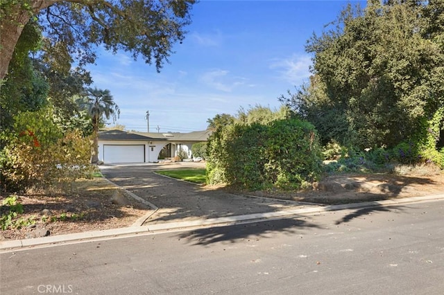 obstructed view of property with a garage