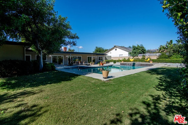 view of pool with a yard and a patio area