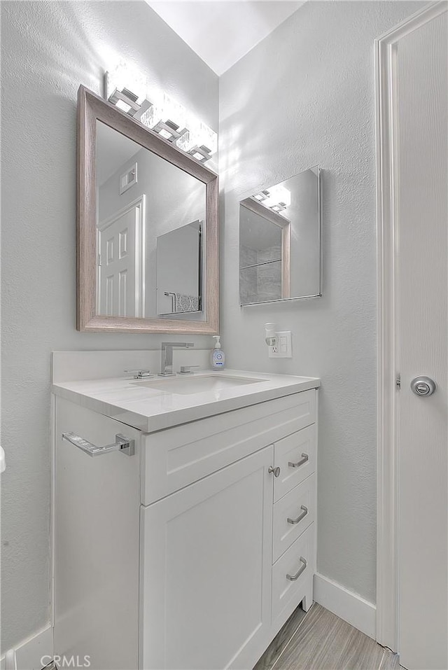 bathroom featuring vanity and wood-type flooring