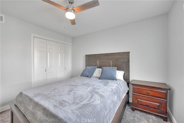 carpeted bedroom with ceiling fan and a closet