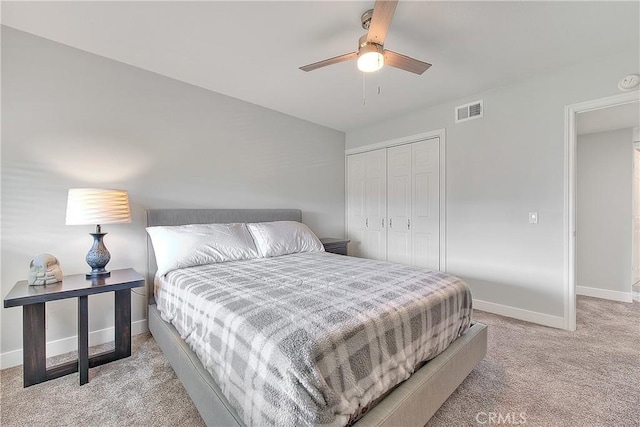 carpeted bedroom with a closet and ceiling fan