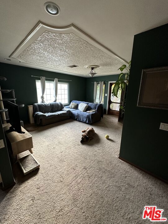 carpeted bedroom featuring a textured ceiling