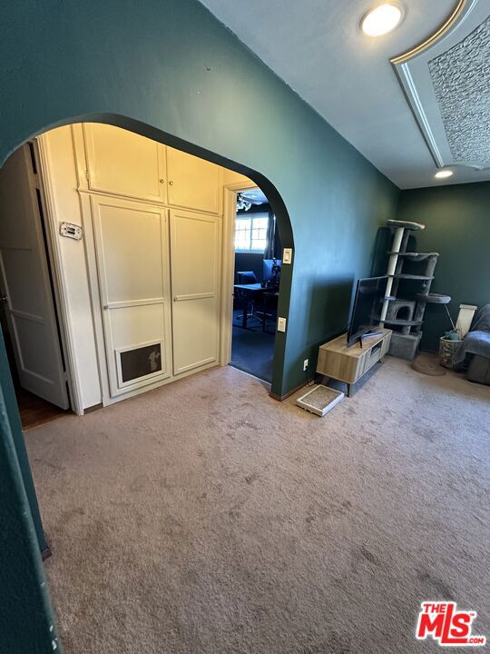 unfurnished living room featuring carpet